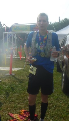 At the finish, with medal and age group award. (After 50 miles this was as close as I could get to a smile. Sorry.)